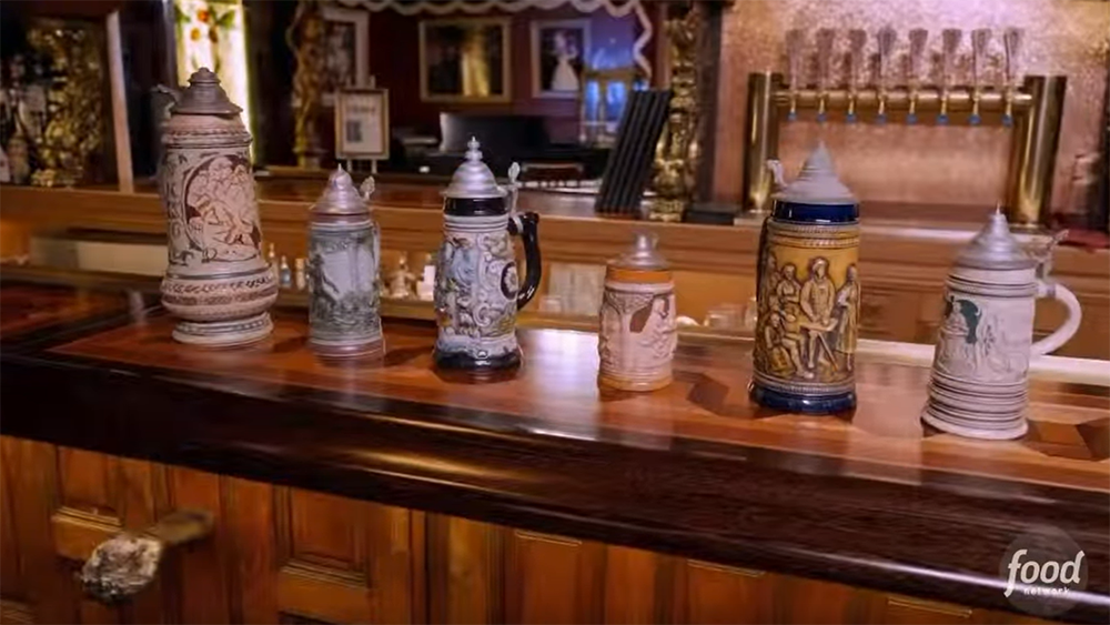 Six decorated beer steins lined up on the Magic Castle’s main bar