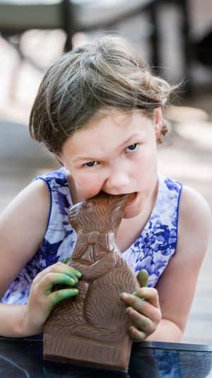 Girl Takes a Bite of a Chocolate Bunny